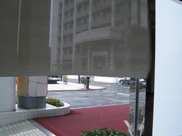 The sunshade screen is made of black fiberglass mesh.